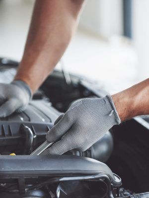 Auto mechanic working in garage. Repair service